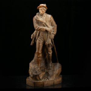 Antique wood sculpture of a hunter